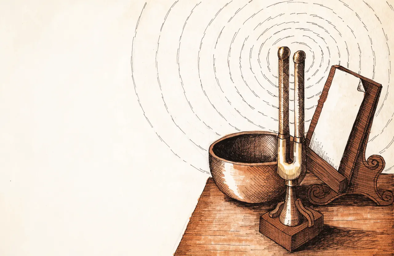 A brass tuning fork in a wooden stand beside a singing bowl and a music stand with a blank sheet, fine sound ripples in the air